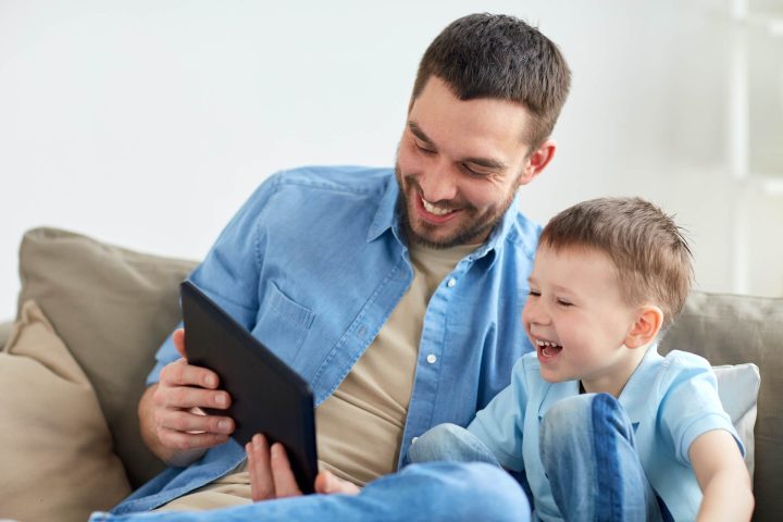 father-and-son-with-tablet-pc-playing-at-home-2024-09-28-03-46-16-utc