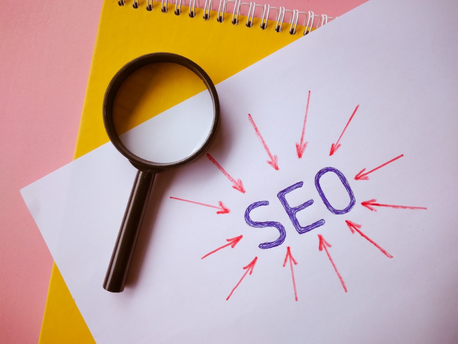 Magnifying glass on SEO letters — search ad campaign optimisation